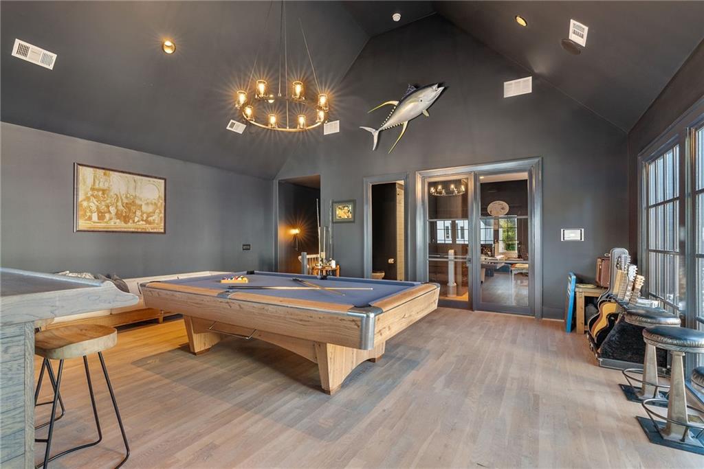6570 Five Oaks Road Cumming, GA 30040 - Photo 77 of 136 a view of a dining room with furniture a chandelier and wooden floor