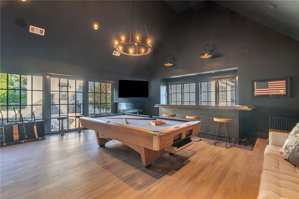 6570 Five Oaks Road Cumming, GA 30040 - Photo 10 of 136 a living room with furniture a flat screen tv and a large window
