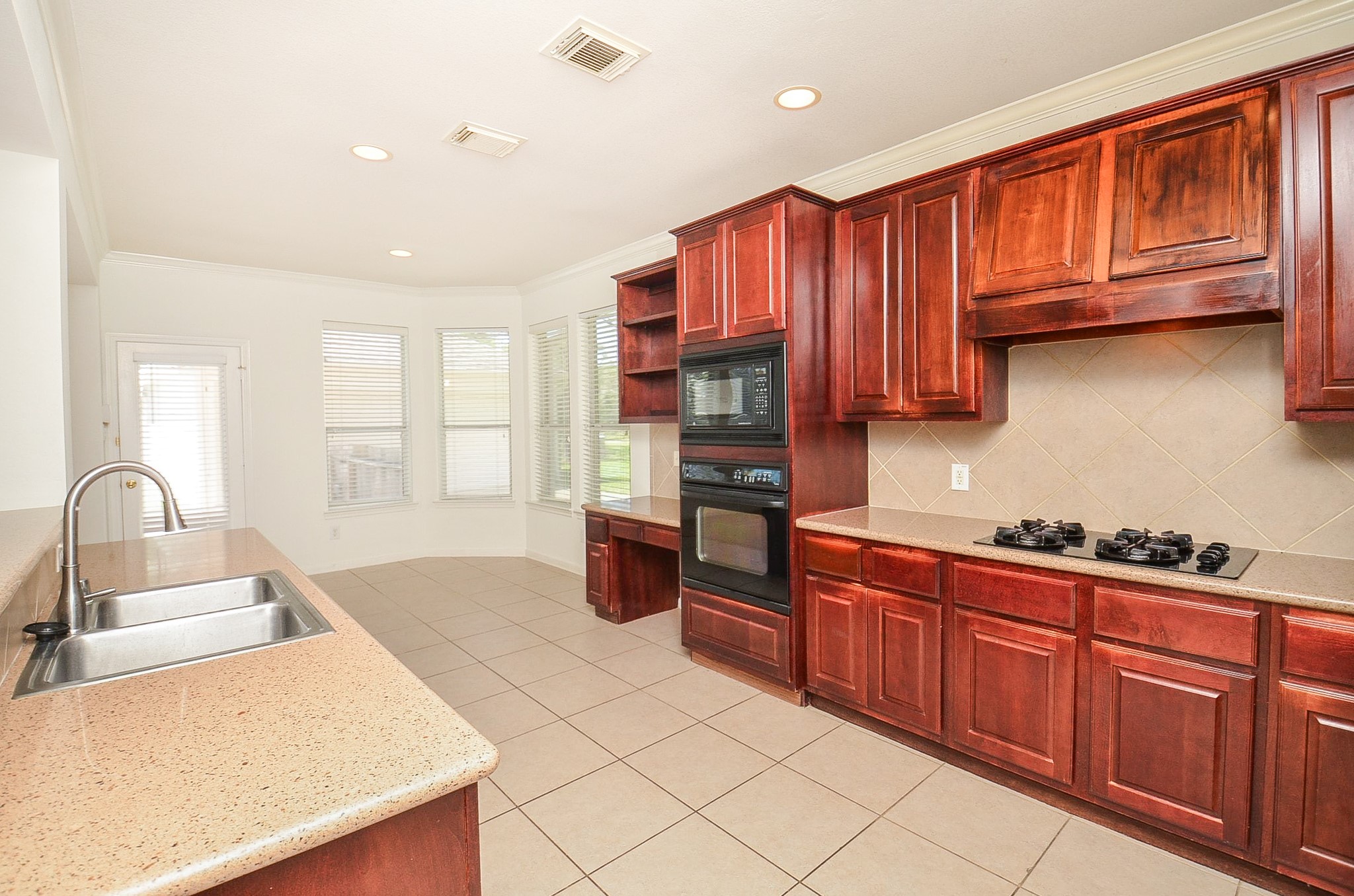 23615 Banning Point Court Katy, TX 77494 - Photo 21 of 50 a kitchen with stainless steel appliances granite countertop a sink dishwasher stove and refrigerator with wooden cabinets