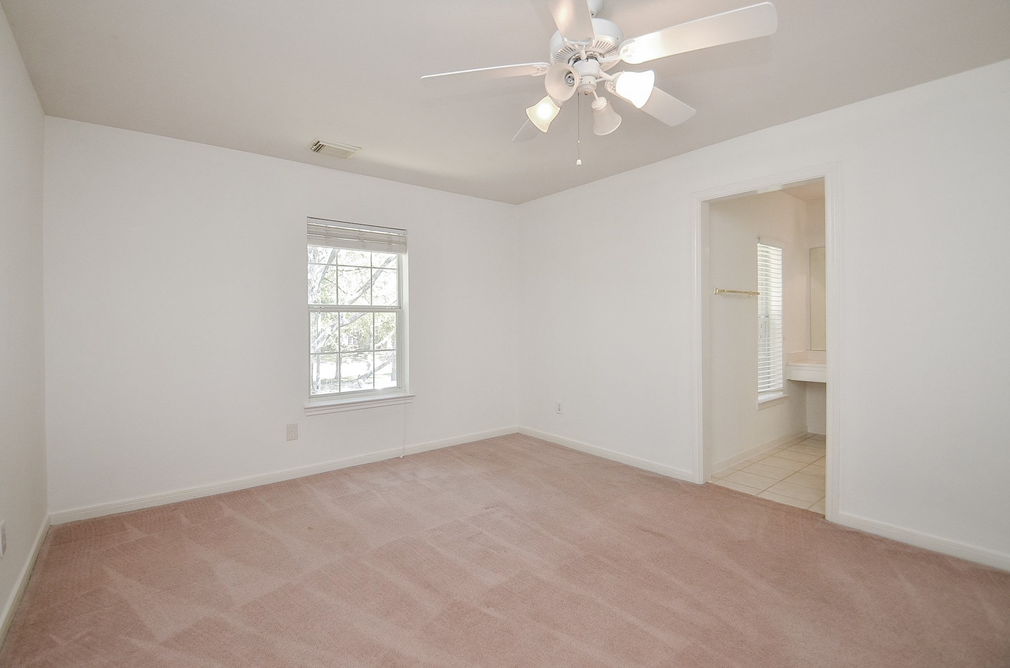 23615 Banning Point Court Katy, TX 77494 - Photo 40 of 50 an empty room with a chandelier fan and windows