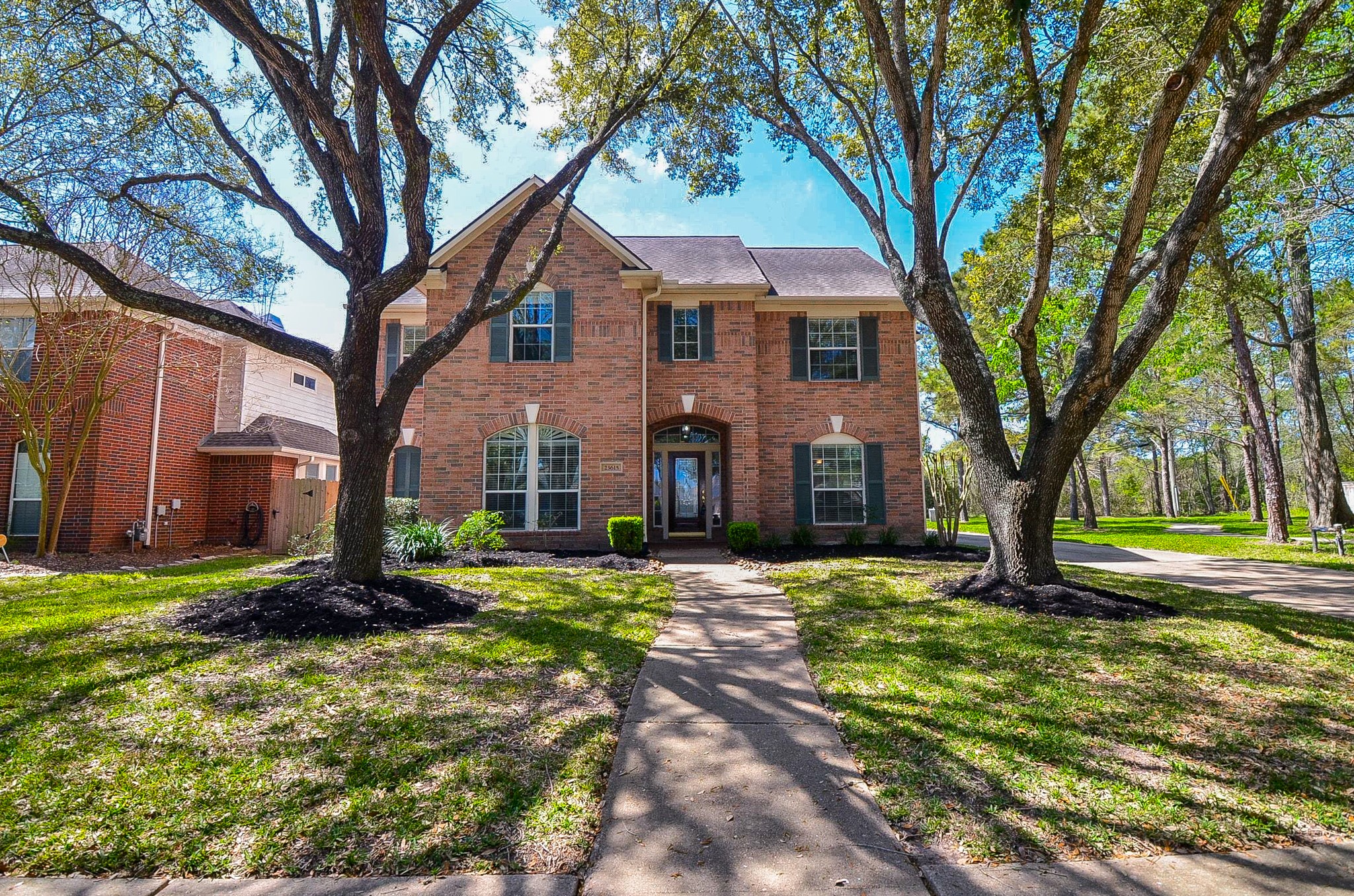23615 Banning Point Court Katy, TX 77494 - Photo 5 of 50 a large tree in front of a brick house