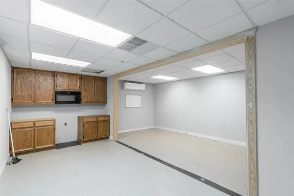 a view of a kitchen with microwave and cabinets