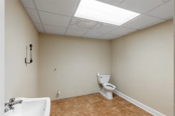 a white toilet sitting next to a bathroom sink