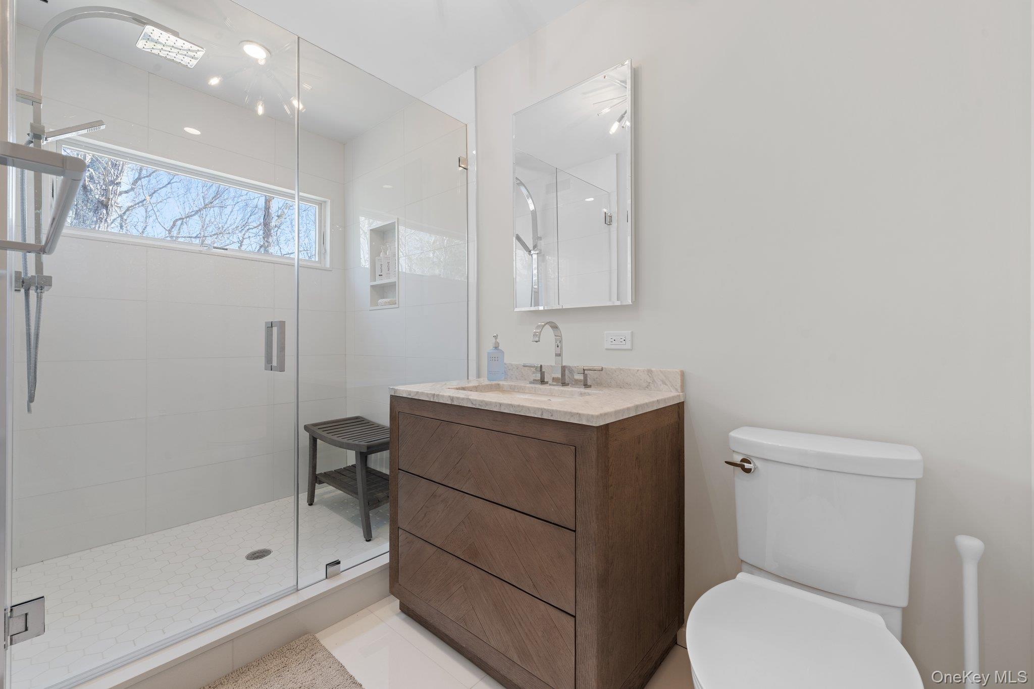 35 Ely Brook Road East Hampton, NY 11937 - Photo 11 of 32 a bathroom with a sink a toilet and shower