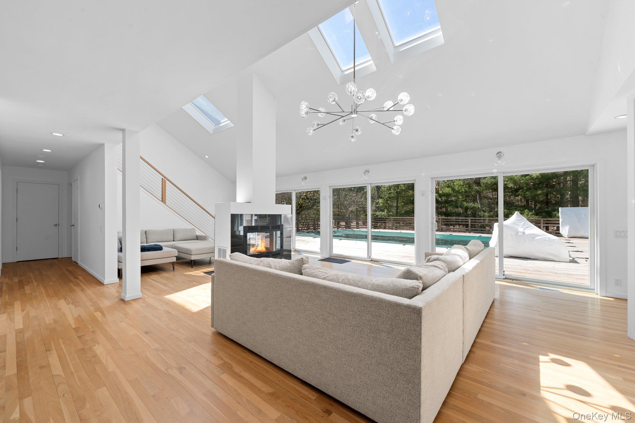 35 Ely Brook Road East Hampton, NY 11937 - Photo 16 of 32 a living room with furniture large window and wooden floor