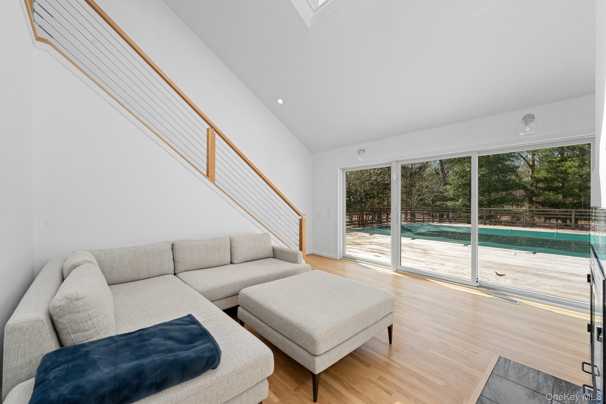 35 Ely Brook Road East Hampton, NY 11937 - Photo 17 of 32 a living room with furniture and a large window