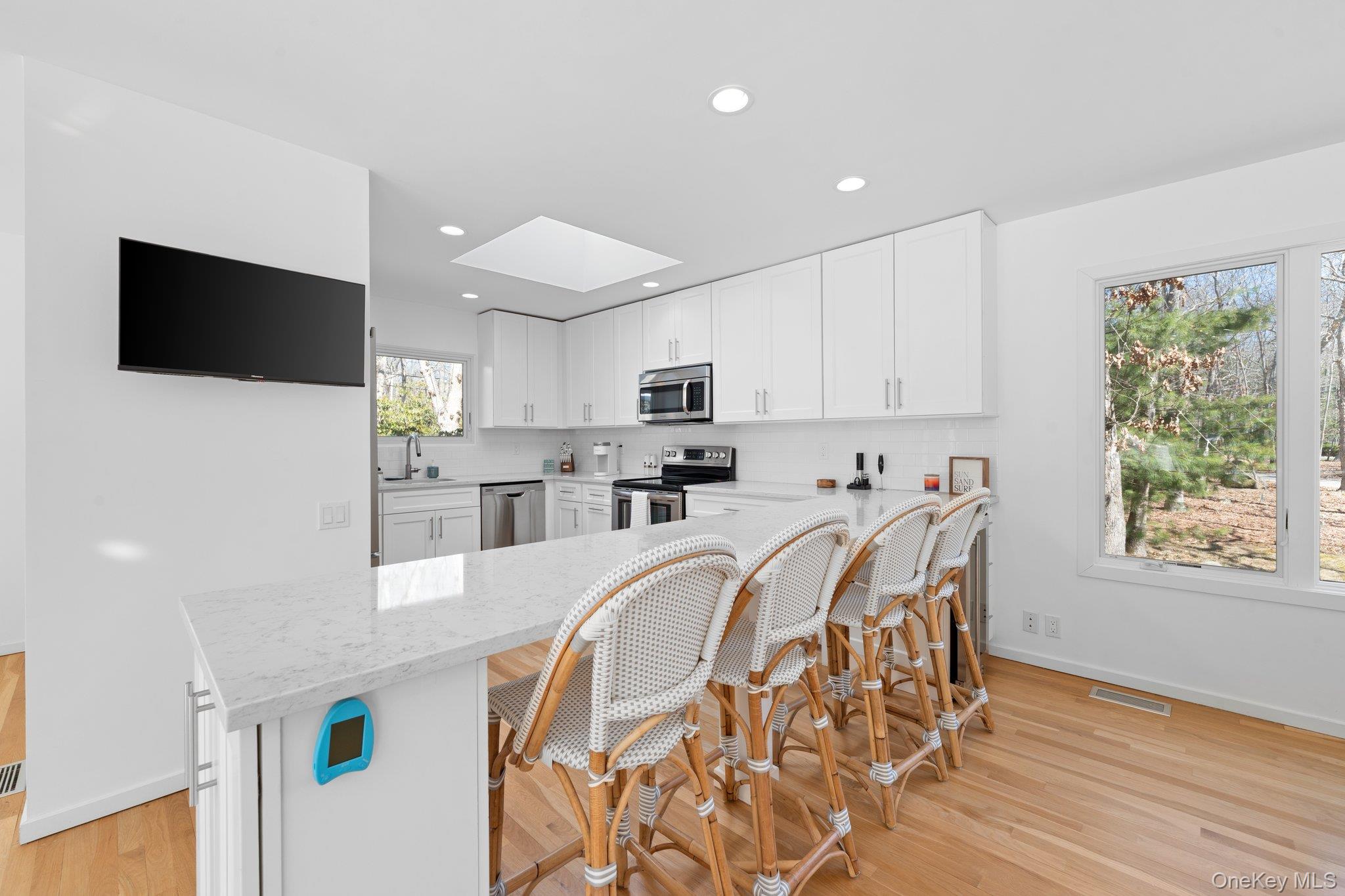 35 Ely Brook Road East Hampton, NY 11937 - Photo 19 of 32 a view of a kitchen with furniture and wooden floor