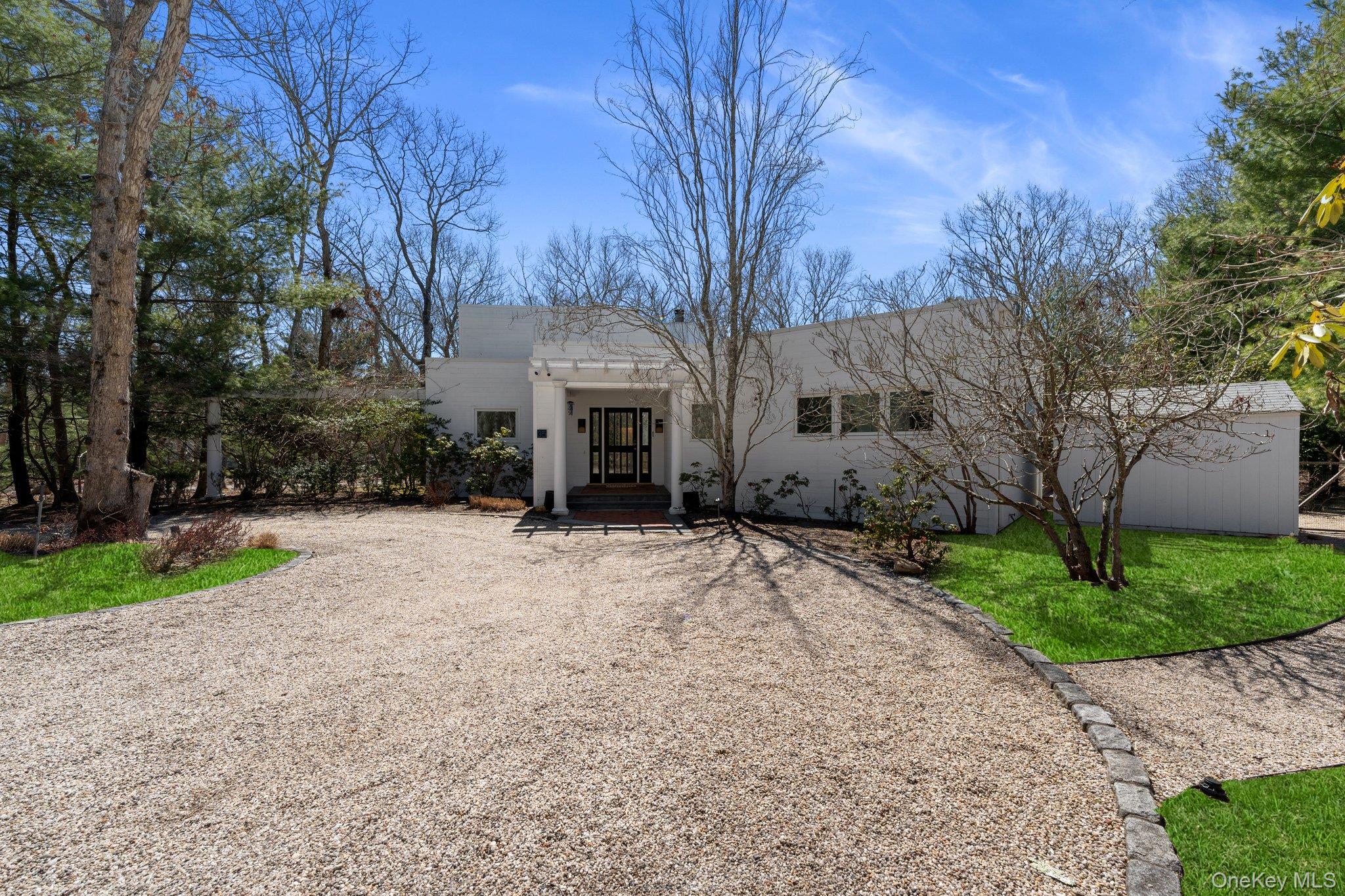 35 Ely Brook Road East Hampton, NY 11937 - Photo 2 of 32 a front view of a house with a yard and garage