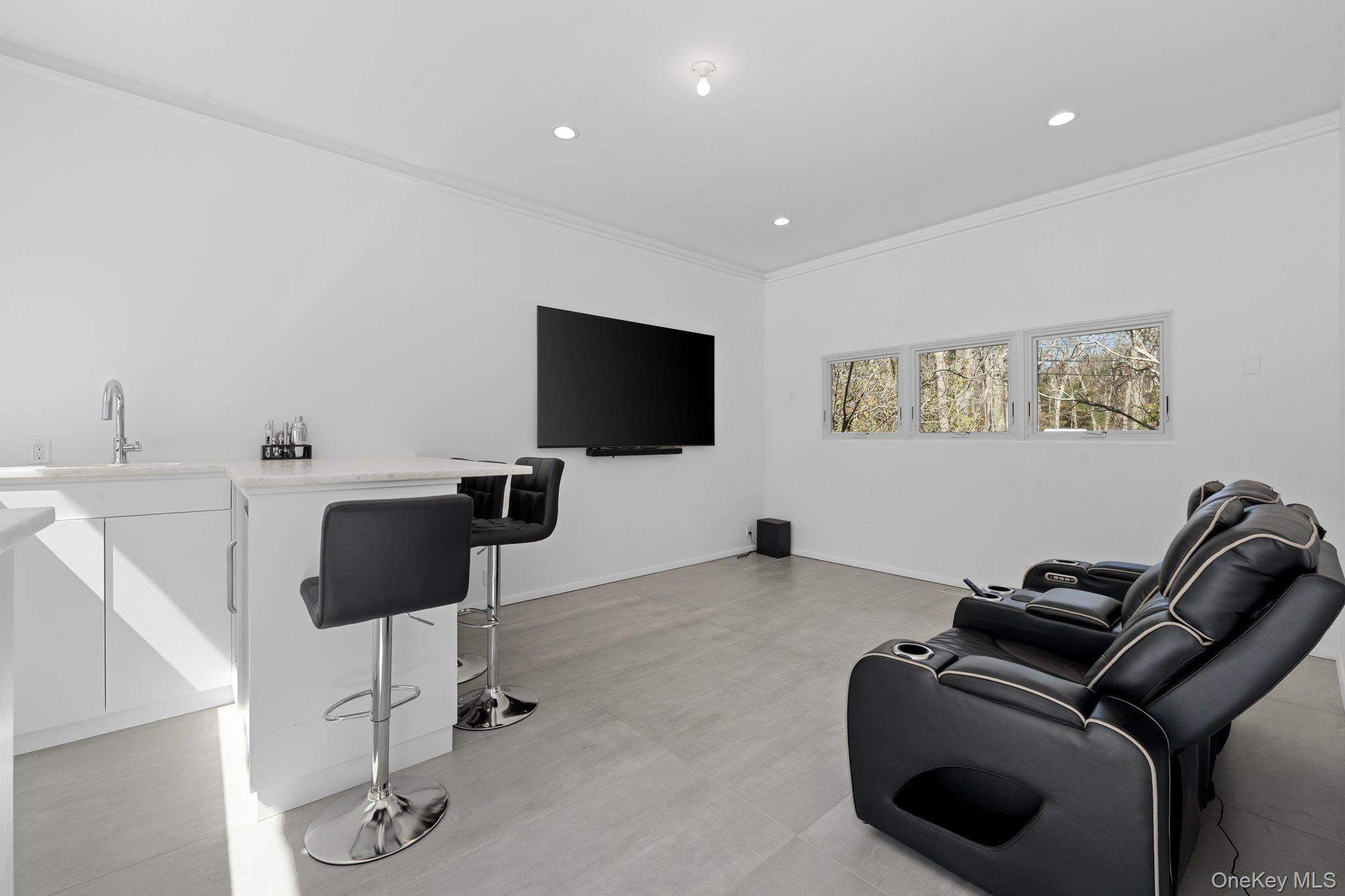 35 Ely Brook Road East Hampton, NY 11937 - Photo 25 of 32 a living room with furniture and a flat screen tv