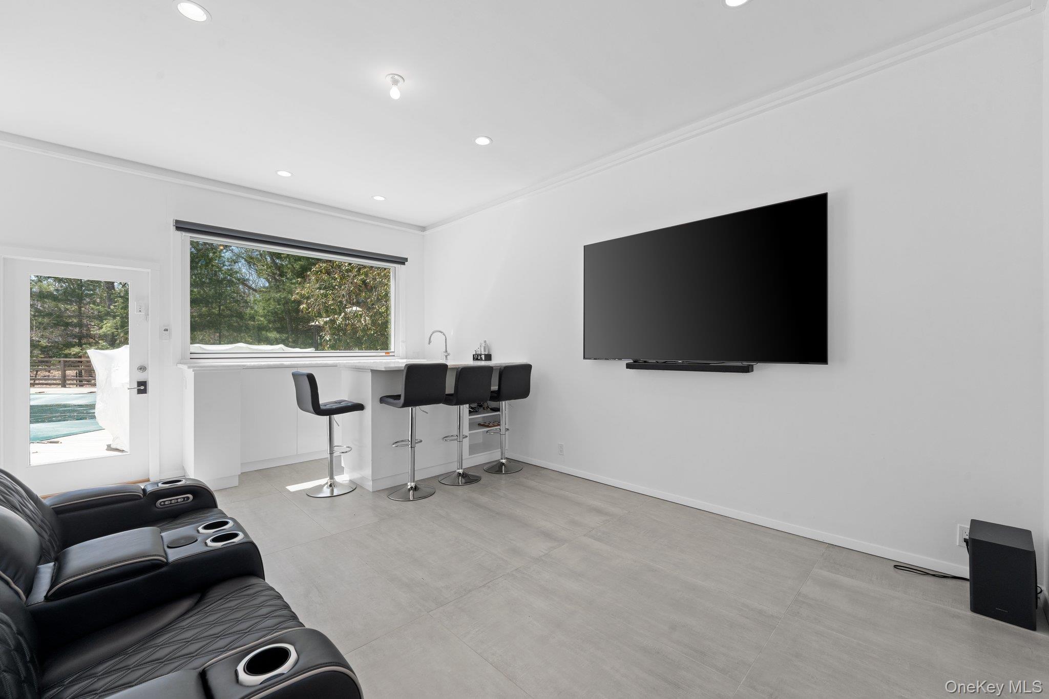 35 Ely Brook Road East Hampton, NY 11937 - Photo 26 of 32 a living room with furniture and a flat screen tv