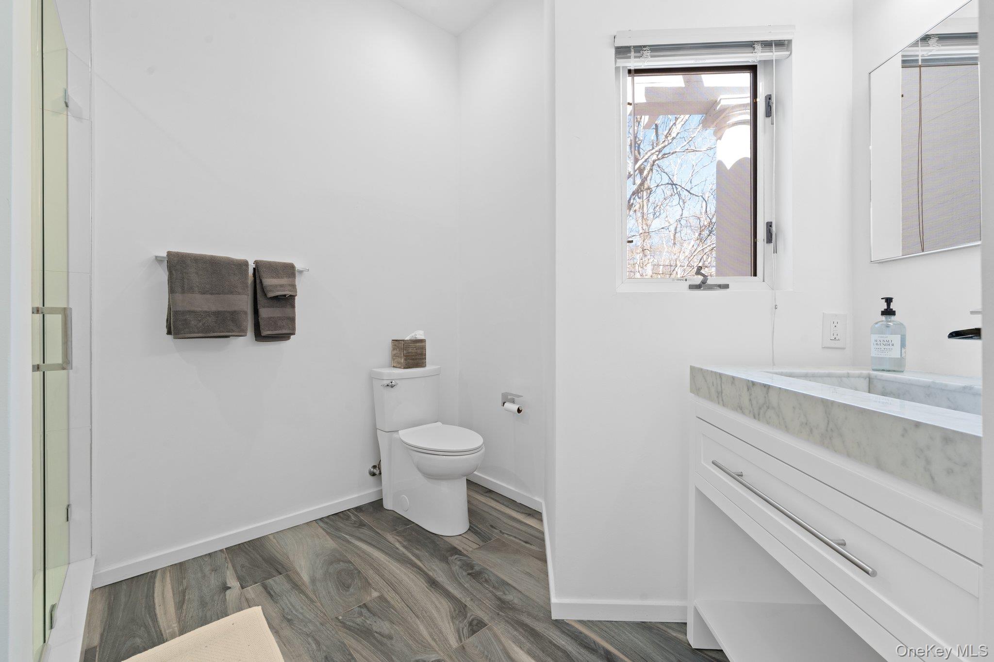 35 Ely Brook Road East Hampton, NY 11937 - Photo 27 of 32 a bathroom with a toilet sink and mirror