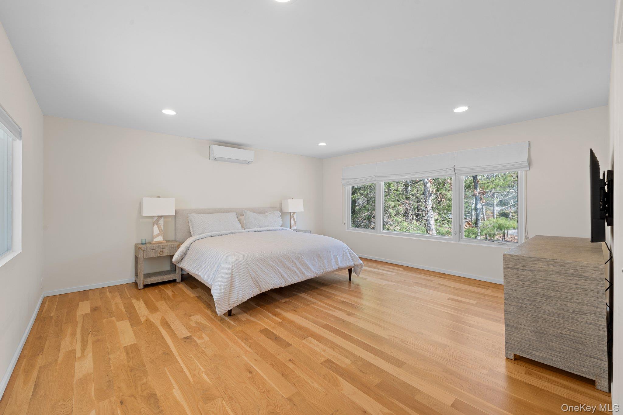 35 Ely Brook Road East Hampton, NY 11937 - Photo 9 of 32 a bedroom with a bed and a large window