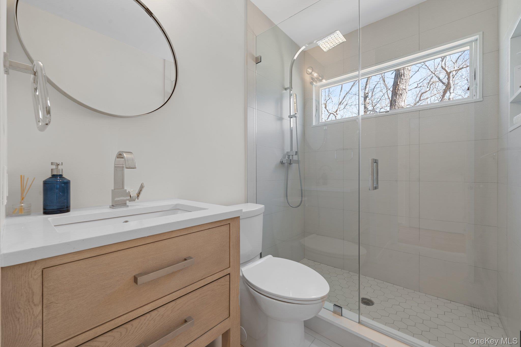 35 Ely Brook Road East Hampton, NY 11937 - Photo 10 of 32 a bathroom with a toilet a sink and shower