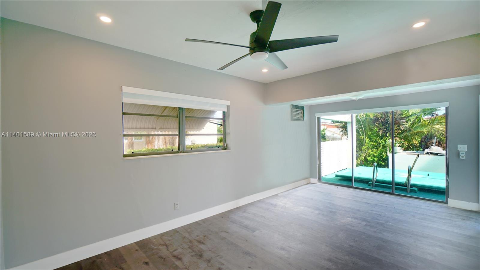 8480 Southwest 32nd Street Miami, FL 33155 - Photo 15 of 24 a view of an empty room with a window and wooden floor