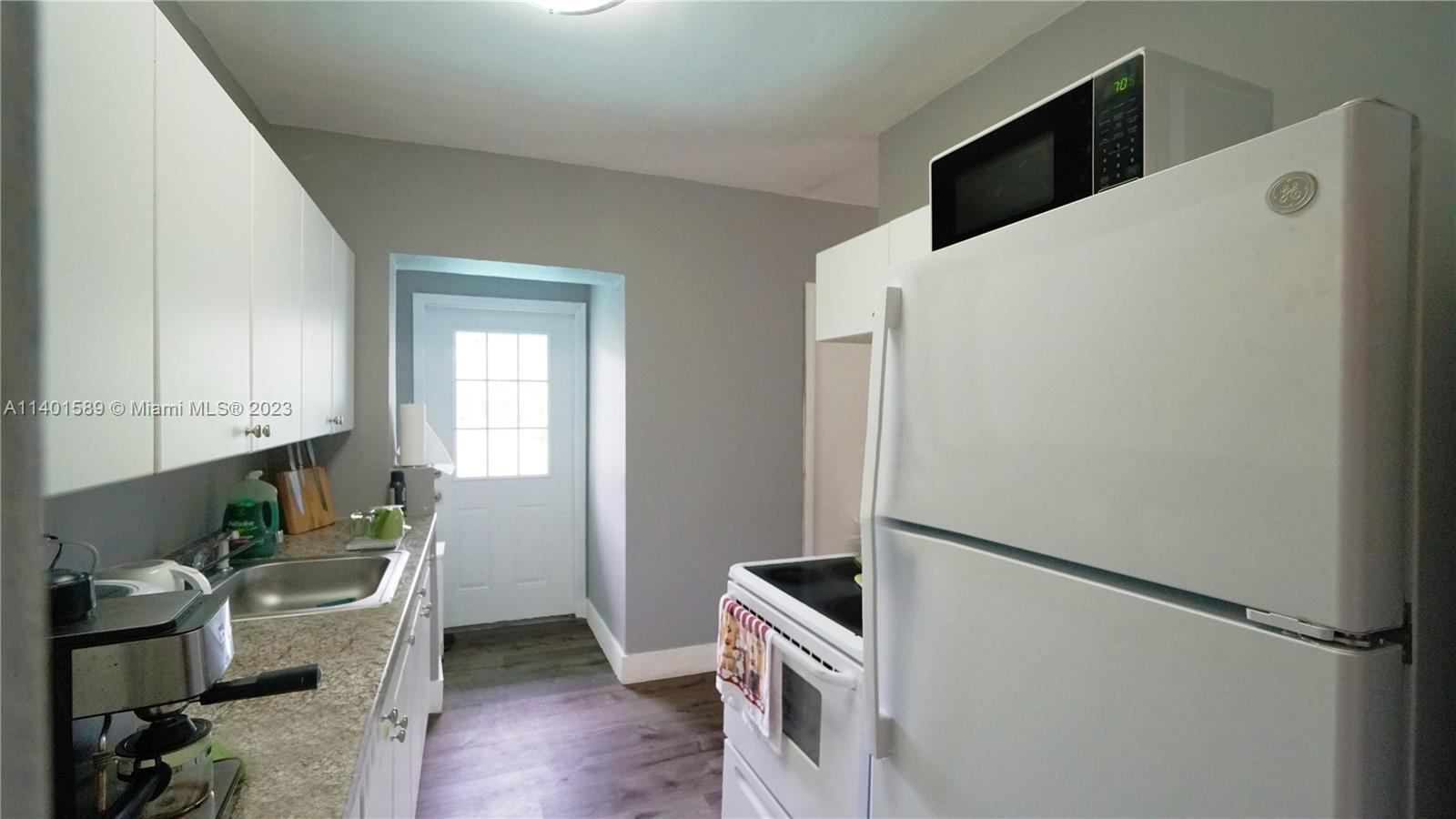 8480 Southwest 32nd Street Miami, FL 33155 - Photo 2 of 24 a kitchen with a refrigerator and a stove