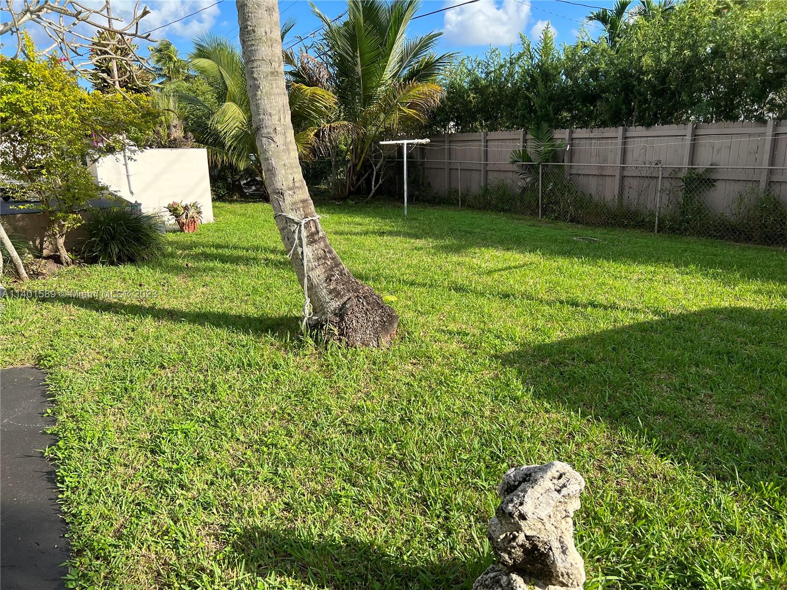 8480 Southwest 32nd Street Miami, FL 33155 - Photo 23 of 24 a view of a garden with a slide and a tree