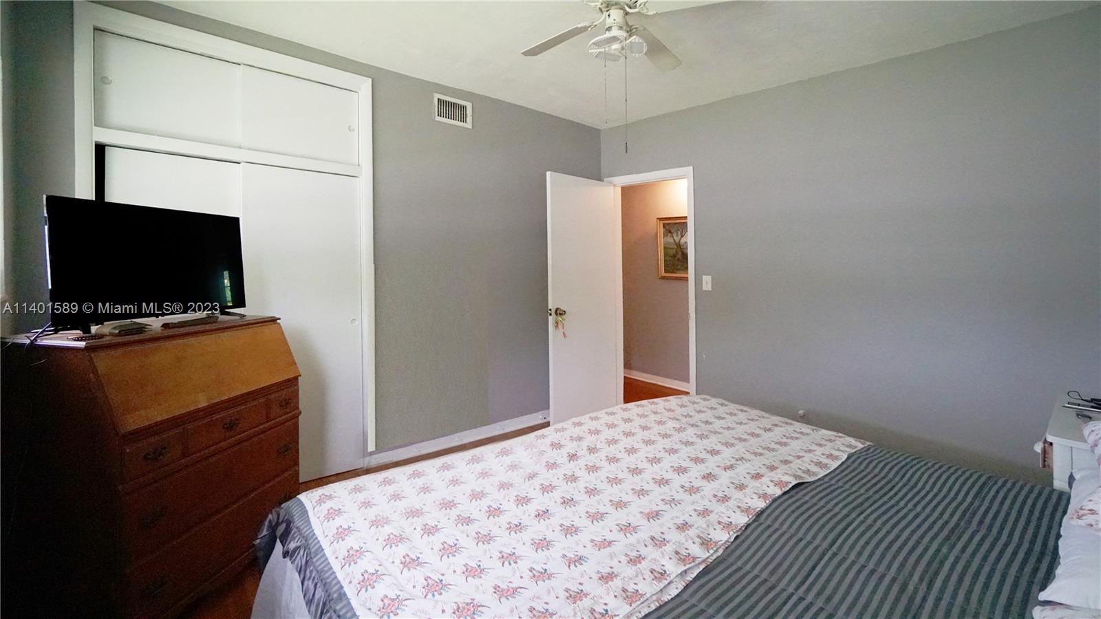 8480 Southwest 32nd Street Miami, FL 33155 - Photo 5 of 24 a bedroom with a bed and a flat screen tv