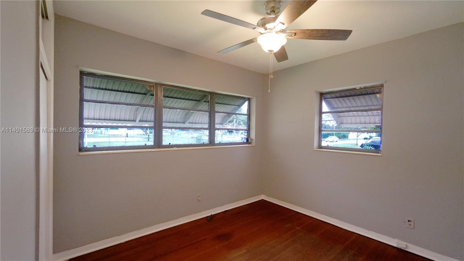 8480 Southwest 32nd Street Miami, FL 33155 - Photo 7 of 24 a view of an empty room with wooden floor and a window