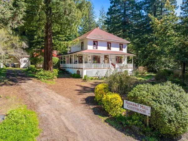 a front view of a house with a yard and fountain