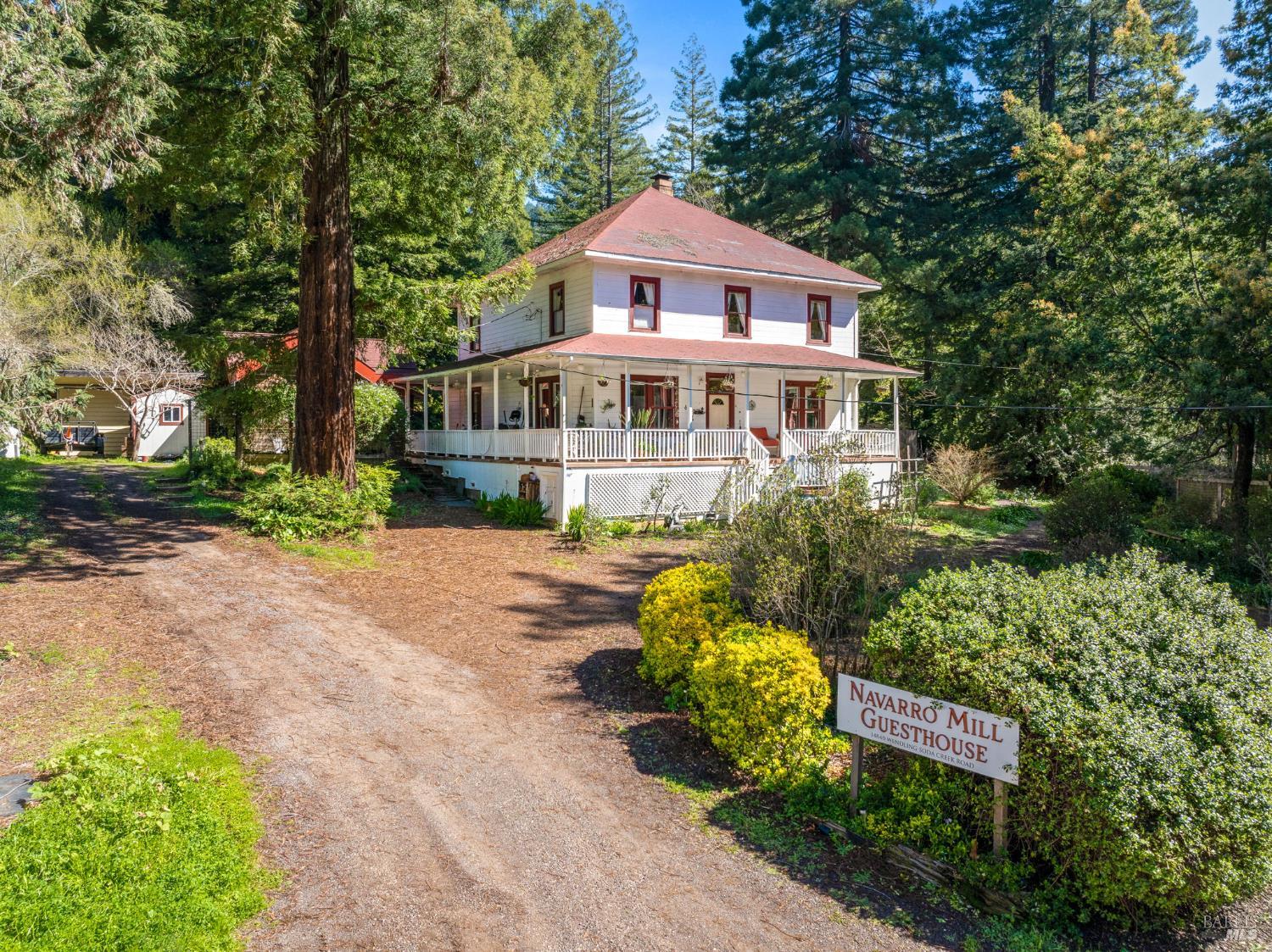 a front view of a house with a yard and fountain