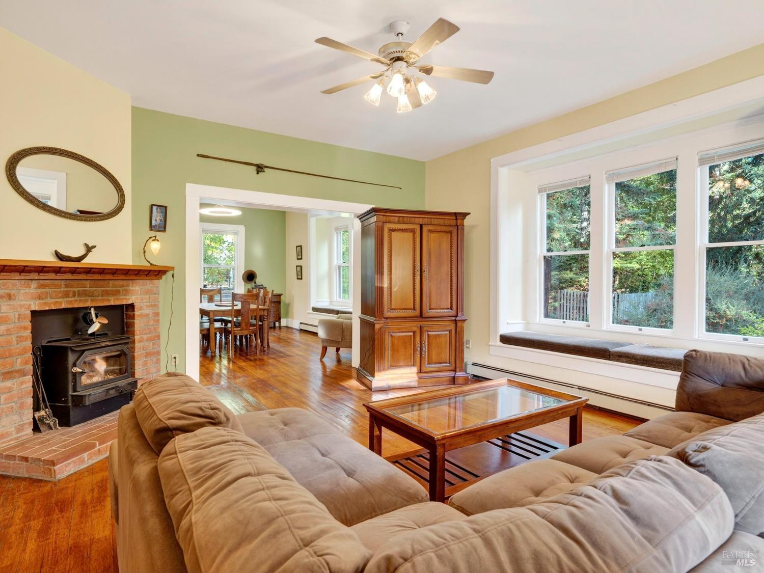 a living room with furniture a fireplace and a large window