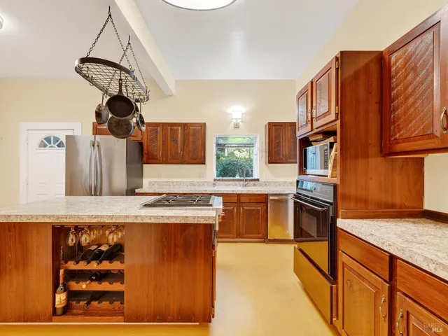 a kitchen with granite countertop cabinets and window