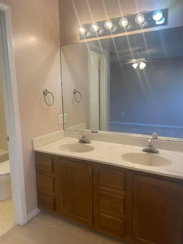 a bathroom with a double vanity sink and a mirror