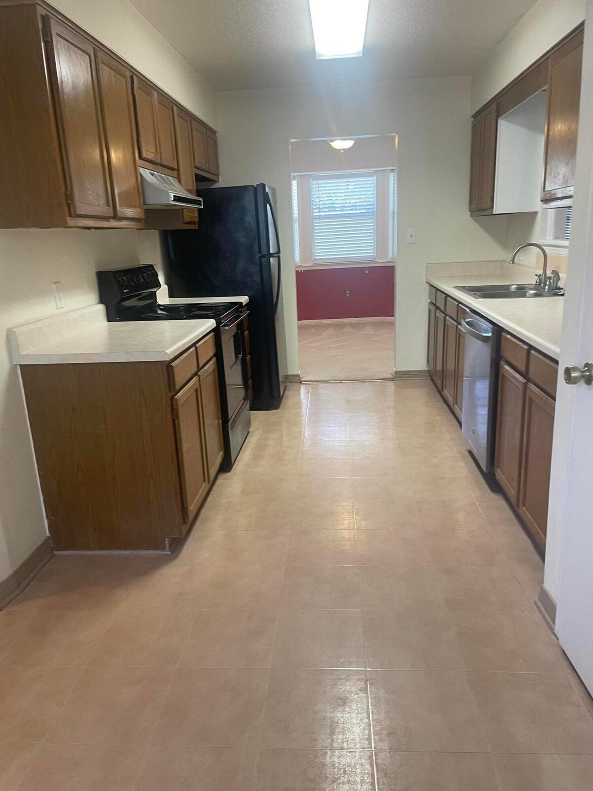1105 Sean Lane Niceville, FL 32578 - Photo 5 of 16 a kitchen with stainless steel appliances a refrigerator and a sink