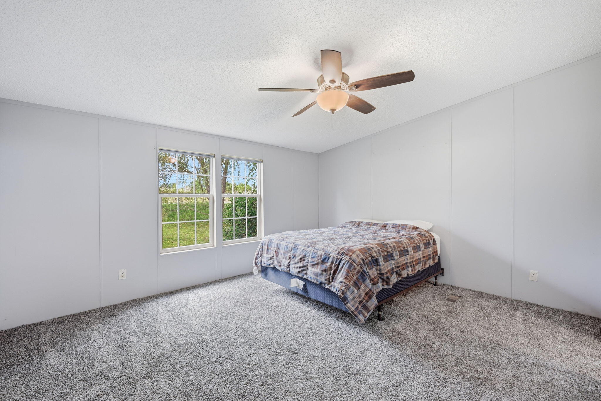 4530 Taft Highway Dry Ridge, KY 41035 - Photo 12 of 42 Grey carpeting, multiple panel walls, dual windows, and a ceiling fan with integrated lighting