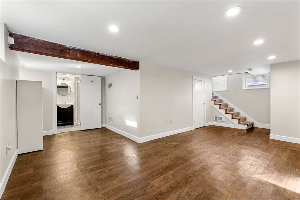 27 Hawthorn Road Milton, MA 02186 - Photo 18 of 26 a view of an empty room with wooden floor