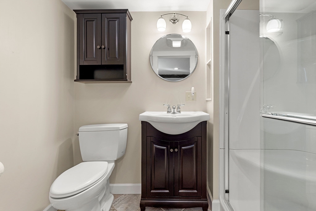 27 Hawthorn Road Milton, MA 02186 - Photo 19 of 26 a bathroom with a toilet a sink and mirror