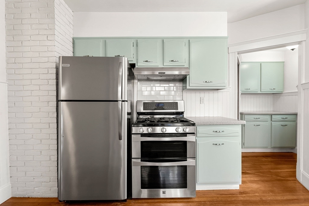 27 Hawthorn Road Milton, MA 02186 - Photo 8 of 26 a kitchen with a refrigerator stove and wooden cabinets