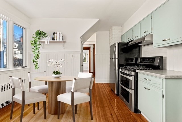 27 Hawthorn Road Milton, MA 02186 - Photo 9 of 26 a kitchen with stainless steel appliances a stove a sink dishwasher and a refrigerator with wooden floor