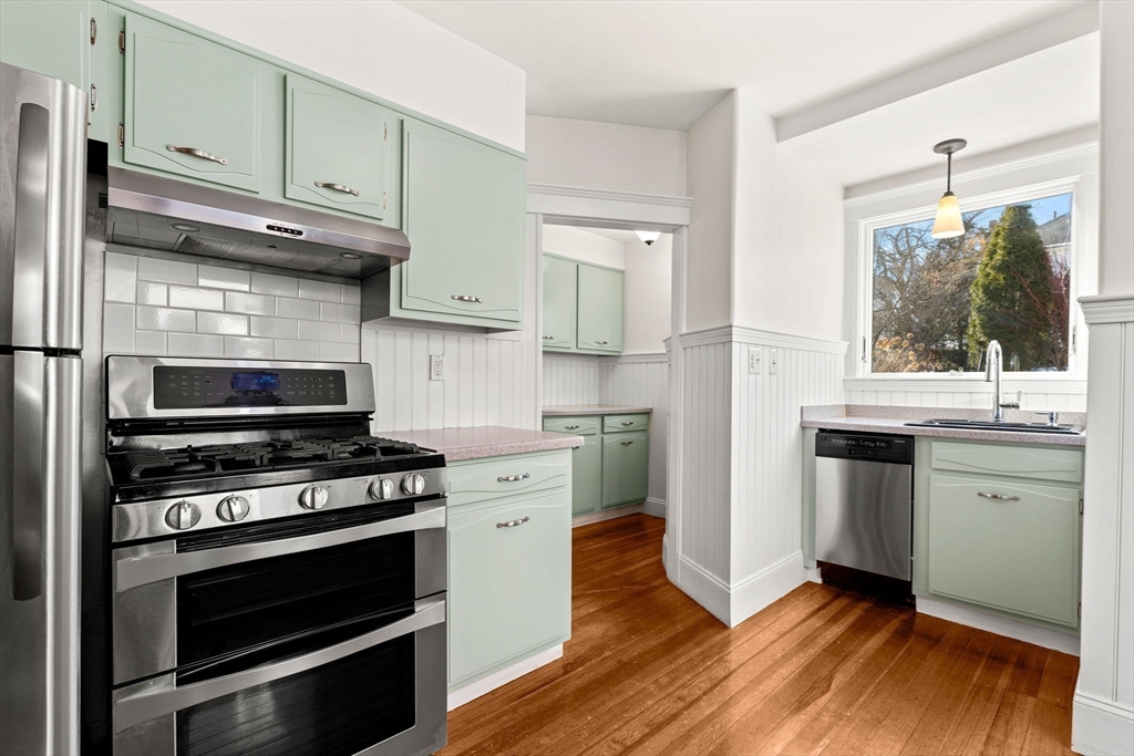 27 Hawthorn Road Milton, MA 02186 - Photo 10 of 26 a kitchen with granite countertop cabinets stainless steel appliances and wooden floor