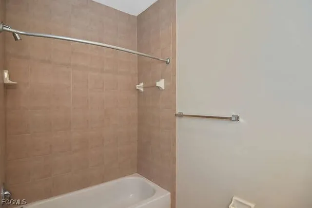 a bathroom with a shower and a bath tub