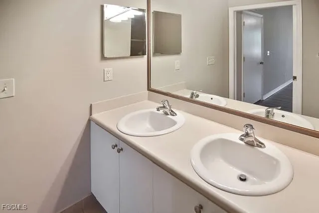 a bathroom with a sink and a mirror