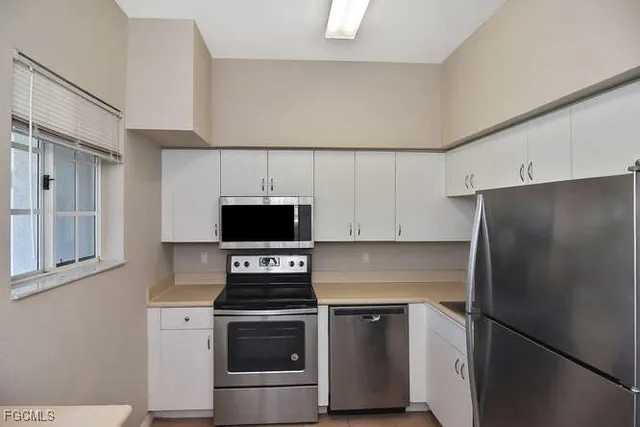 a kitchen with a refrigerator stove and microwave