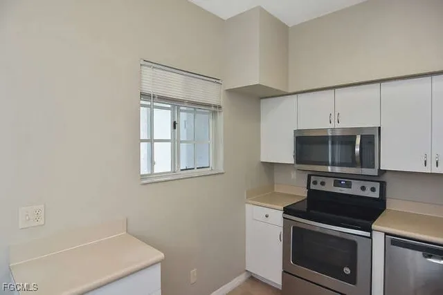 a kitchen with a stove microwave and sink