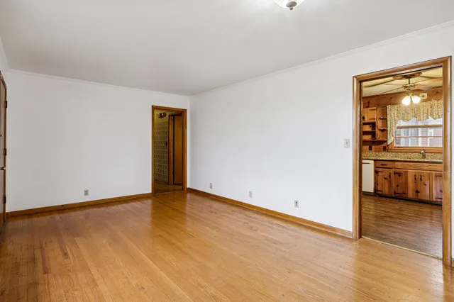 a view of a room with wooden floor and a sink