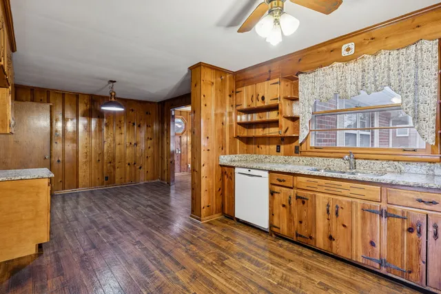 a kitchen with stainless steel appliances granite countertop a stove and a wooden floors