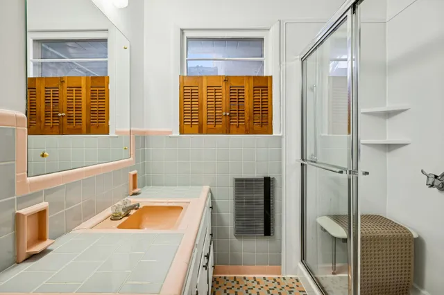 a bathroom with a tub a sink and a window