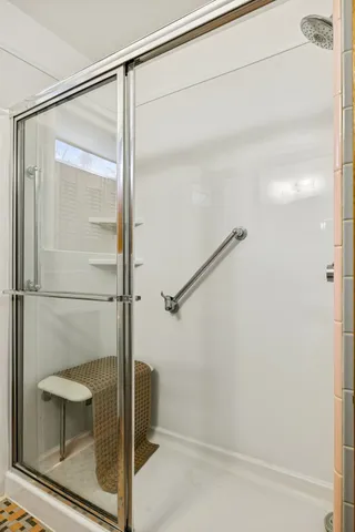 a bathroom with a glass shower door
