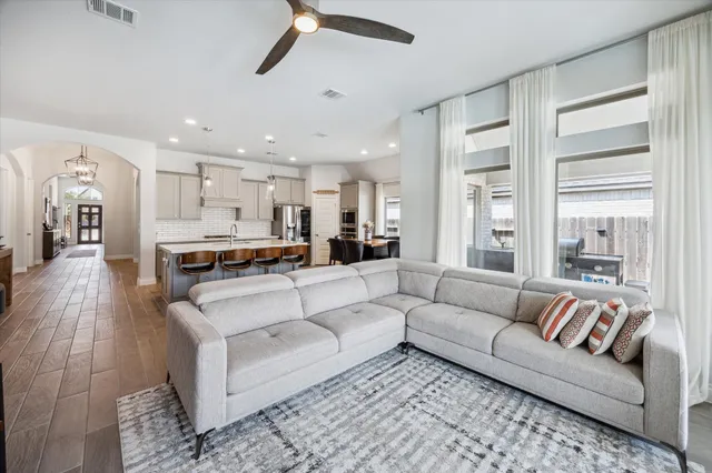a living room with furniture and a large window