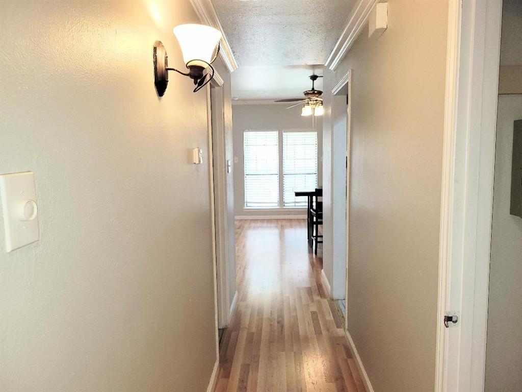 2835 Keller Springs Road, Unit 1103 Carrollton, TX 75006 - Photo 2 of 14 a view of a hallway with wooden floor closet and livingroom view