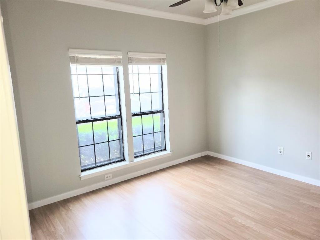 2835 Keller Springs Road, Unit 1103 Carrollton, TX 75006 - Photo 3 of 14 an empty room with wooden floor and windows