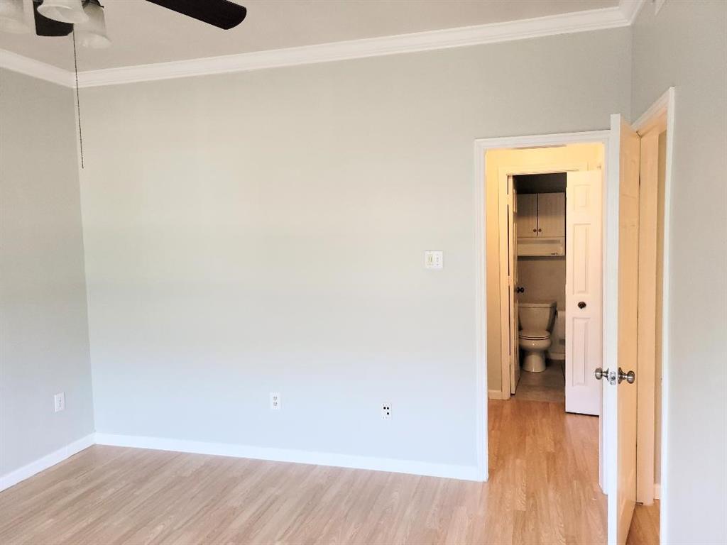 2835 Keller Springs Road, Unit 1103 Carrollton, TX 75006 - Photo 4 of 14 a view of an empty room with wooden floor