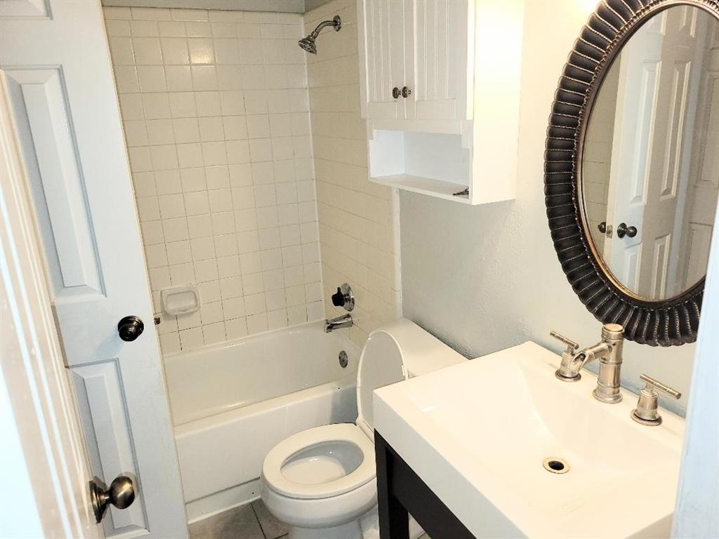 2835 Keller Springs Road, Unit 1103 Carrollton, TX 75006 - Photo 7 of 14 a bathroom with a sink a toilet and a mirror