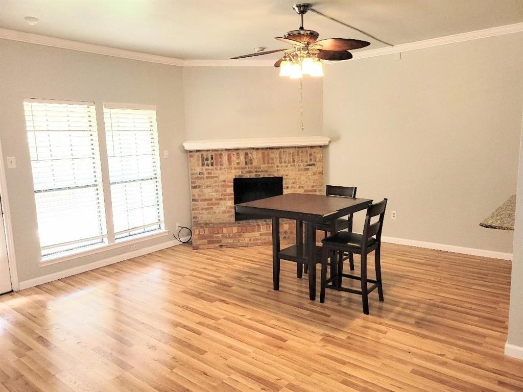 2835 Keller Springs Road, Unit 1103 Carrollton, TX 75006 - Photo 8 of 14 a view of a dining room with furniture and wooden floor