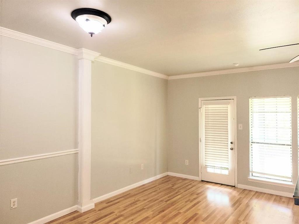 2835 Keller Springs Road, Unit 1103 Carrollton, TX 75006 - Photo 9 of 14 an empty room with wooden floor and windows