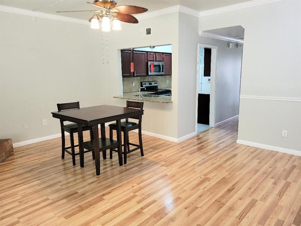 2835 Keller Springs Road, Unit 1103 Carrollton, TX 75006 - Photo 10 of 14 a view of a dining room with furniture and wooden floor